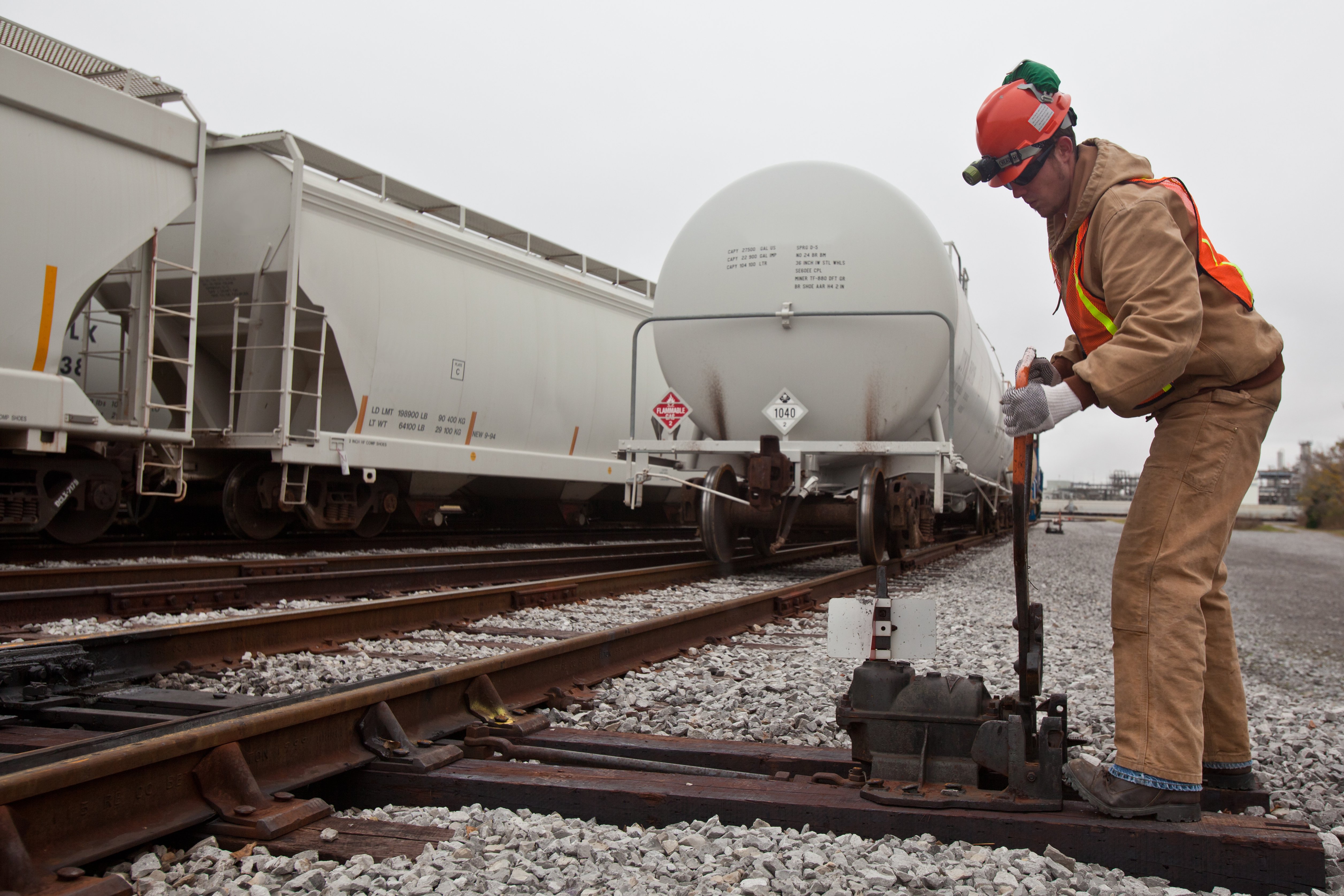 A rail switchman working in a plant rail yard